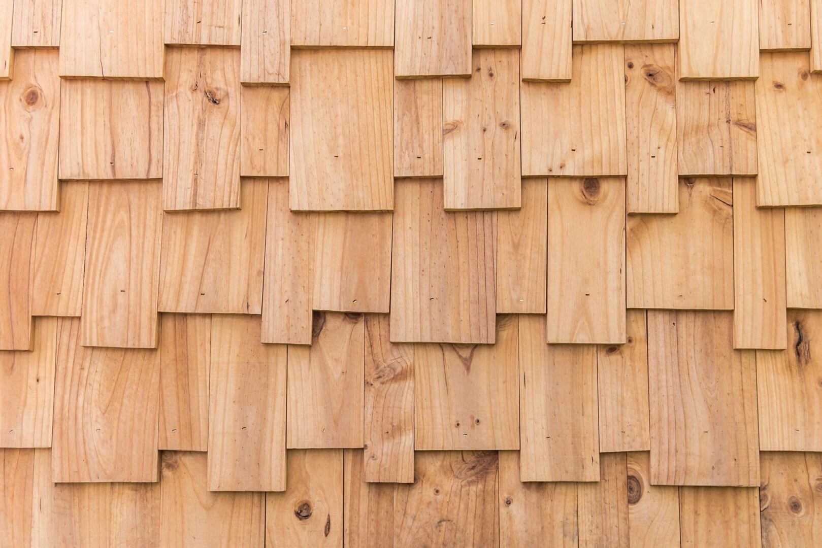 A close up of the wood shingles on a house
