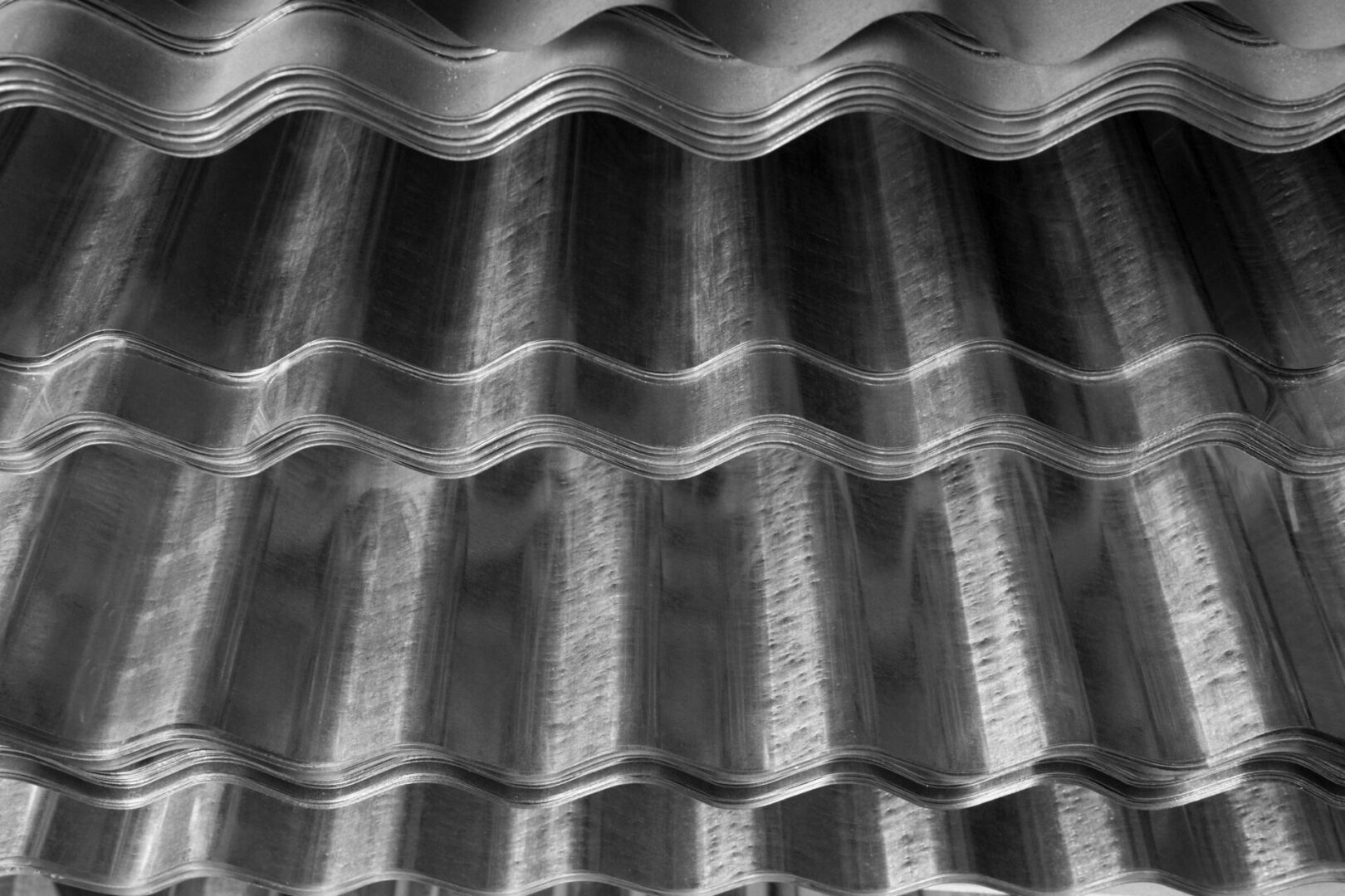A black and white photo of some wavy metal sheets.