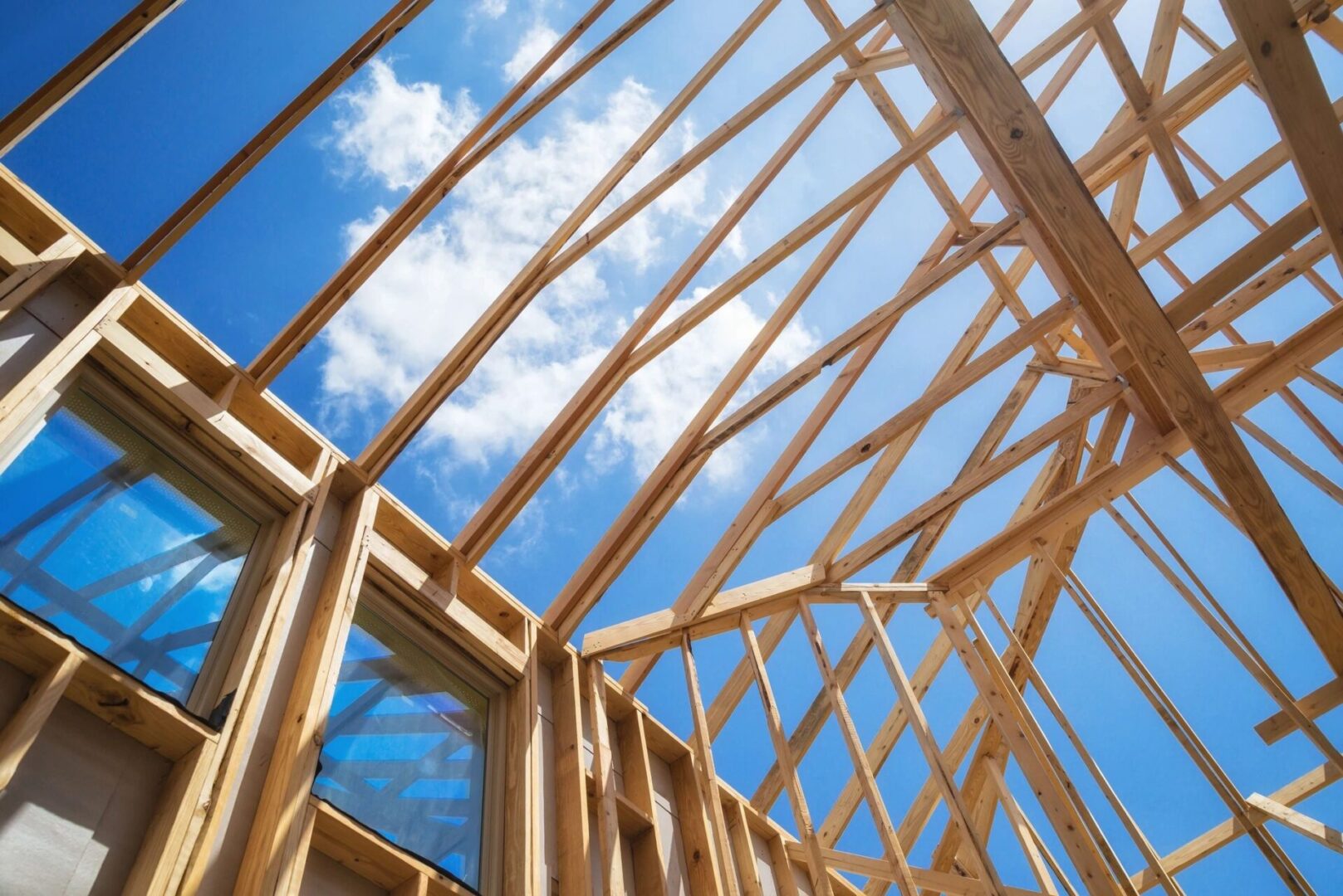A wooden structure under construction with blue sky in the background.