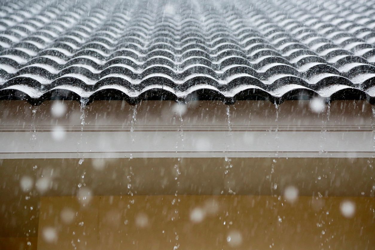 A rain falling on the roof of a house.