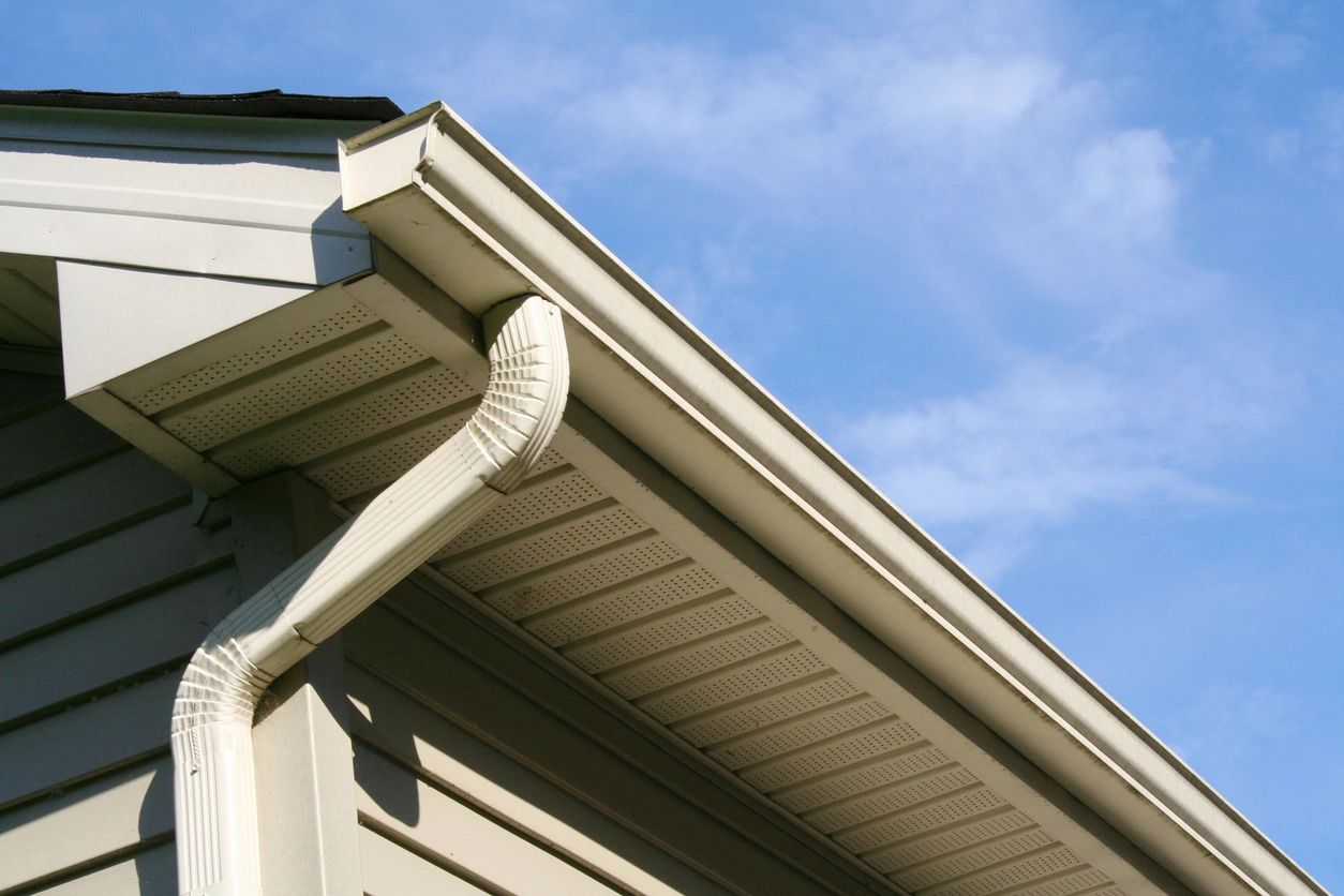 A close up of the side of a house with a gutter