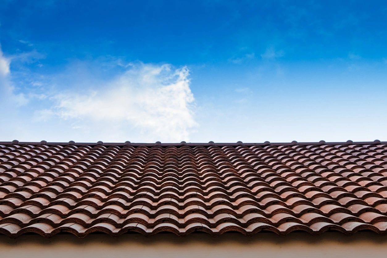 A brown roof with a sky background